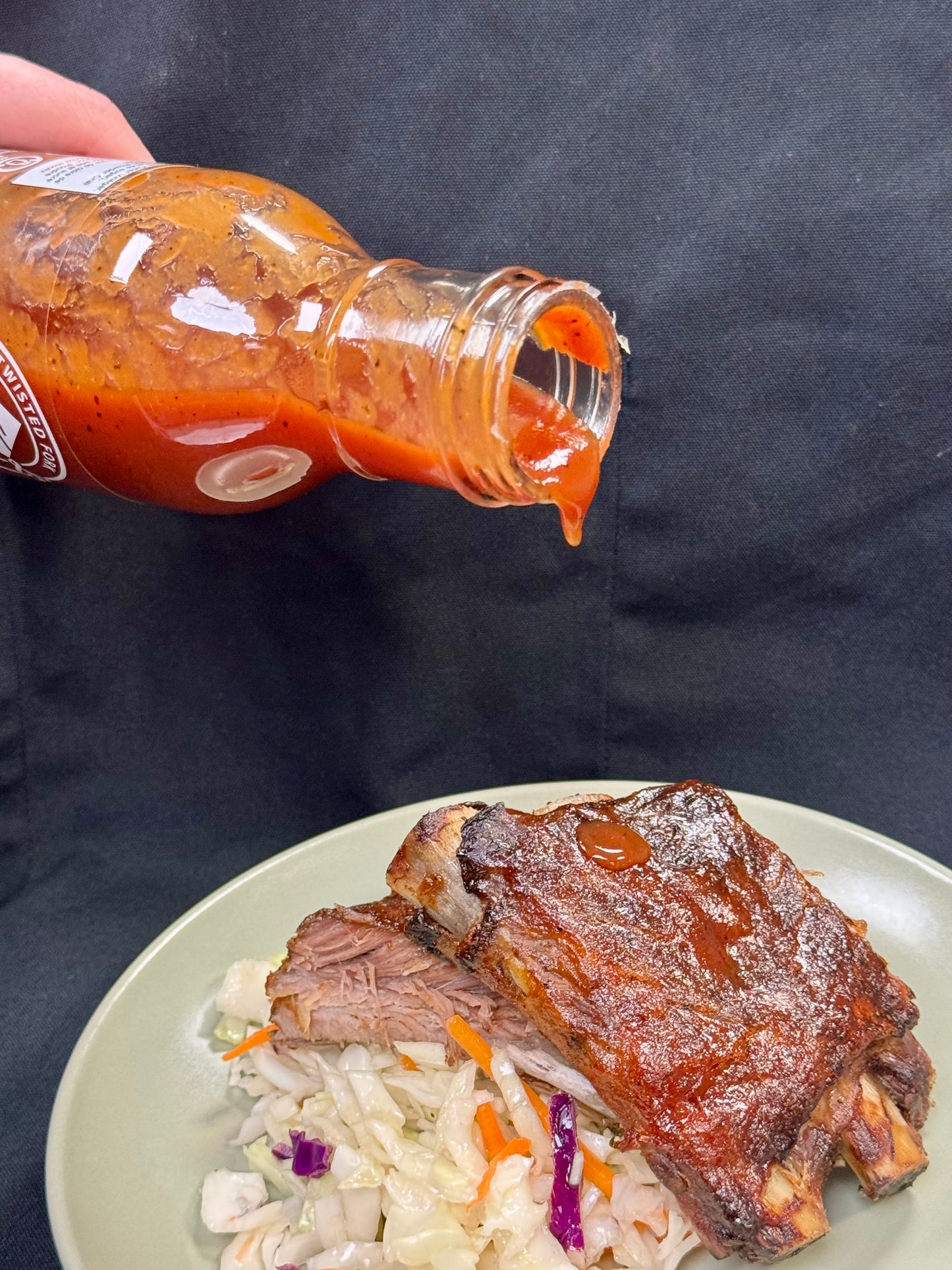 bbq sauce pouring on to ribs