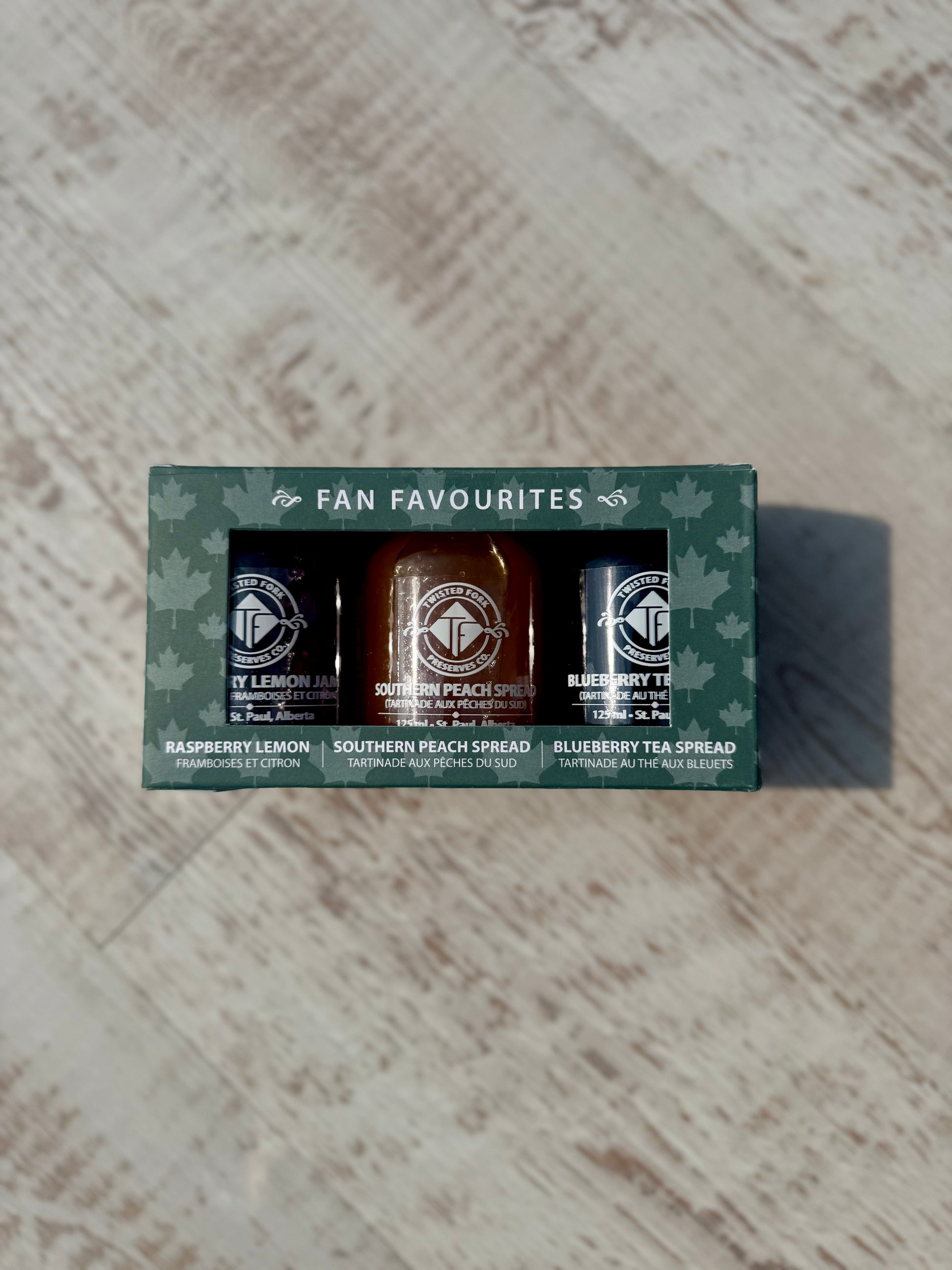 Packaged set of three spreads with a green box labeled 'Fan Favourites' on a textured surface.