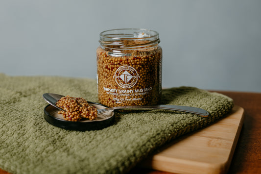 whiskey mustard on spoon in lid