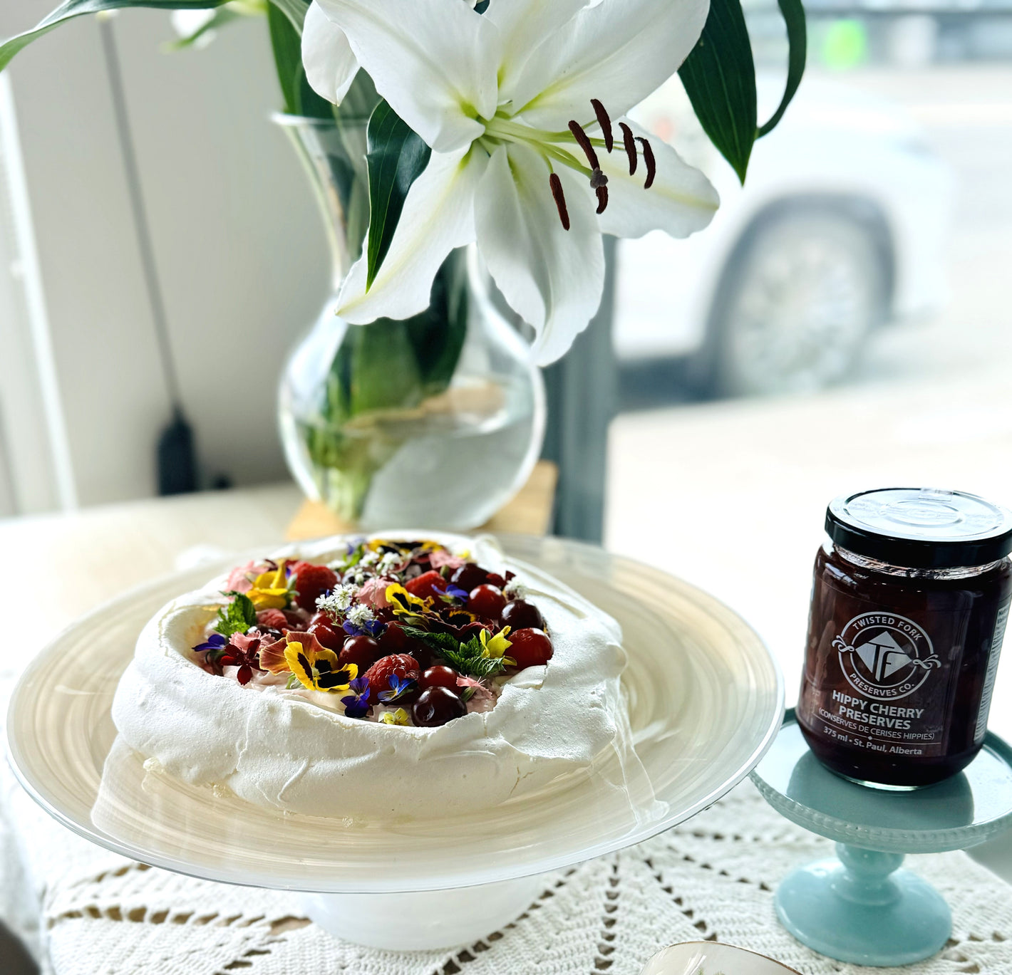 dessert pavlova made with Hippy Cherry and edible flowers